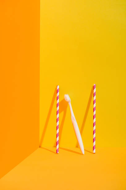istock straws and white toothbrush standing at orange wall 918248806