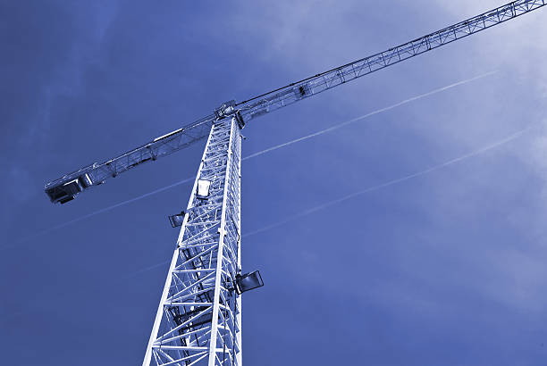 construction crane against blue sky stock photo