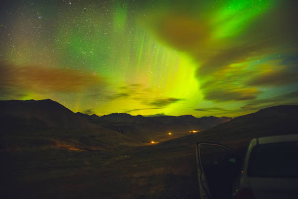 Impressive green Aurora Borealis (Northern lights) in Iceland.Northern pole phenomenon.Visible polar light,magnetic particle collision display.Natural light show above arctic circle mountains. stock photo