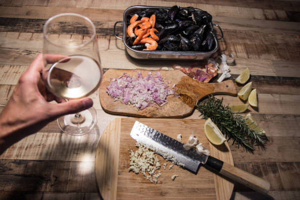 Two glasses and a bottle of red wine on a light background. Horizontal photo