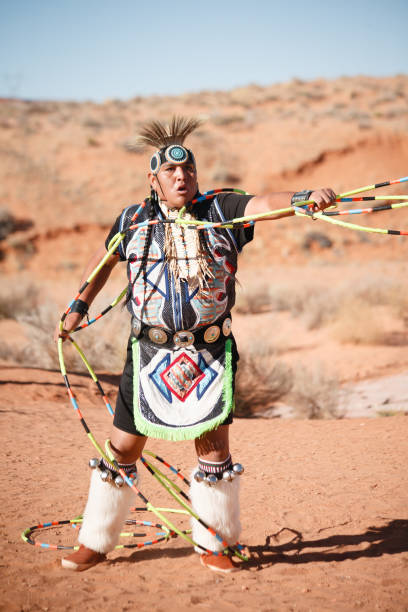 A Navajo Native American Man performs traditional hoop dance stock photo