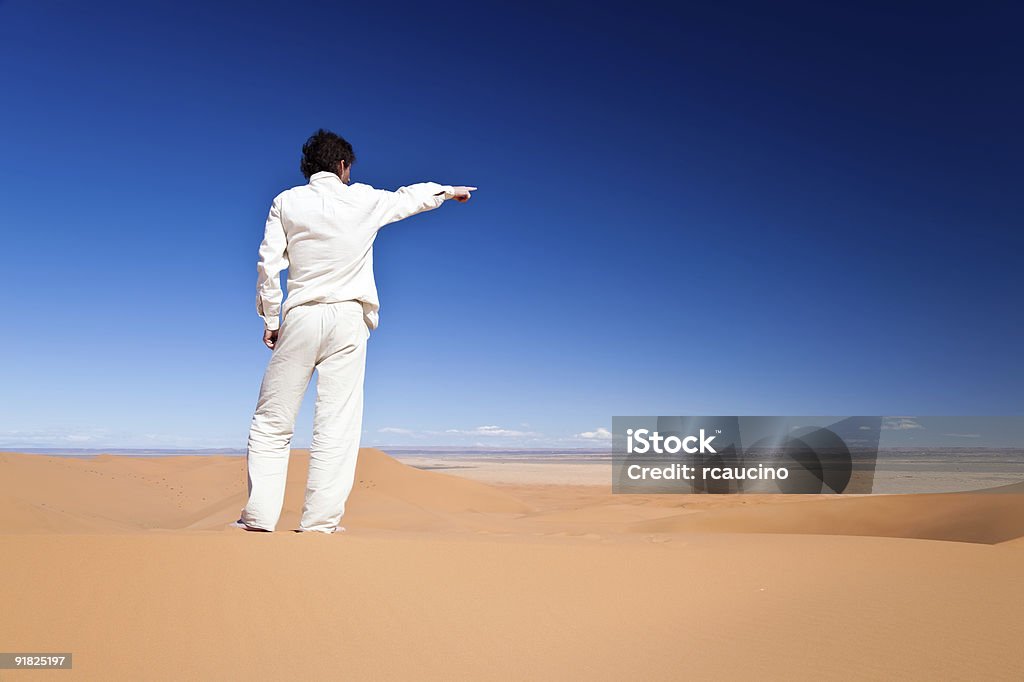 Man standing on a sand dune  Adult Stock Photo
