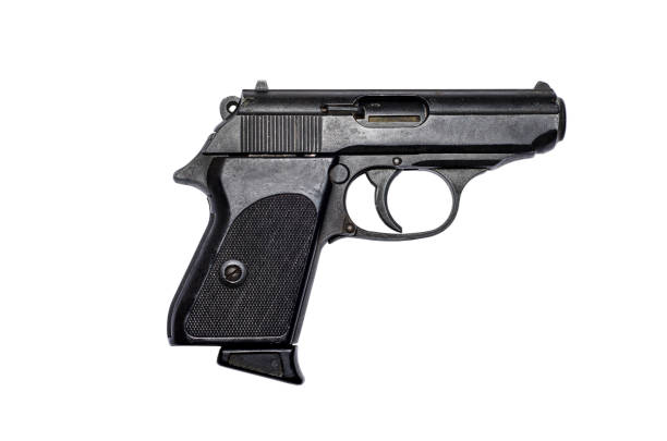 istock Used black metal pistol gun on white background 918252244