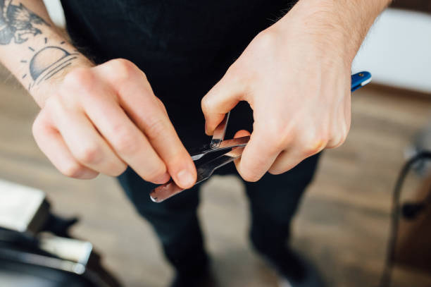 istock Barber prepares dangerous razor for shaving beard 918255326