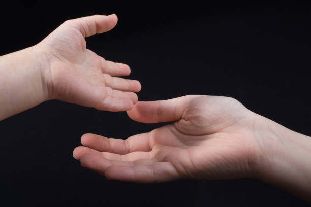 istock Hand is giving out cigarette on black background 918255494