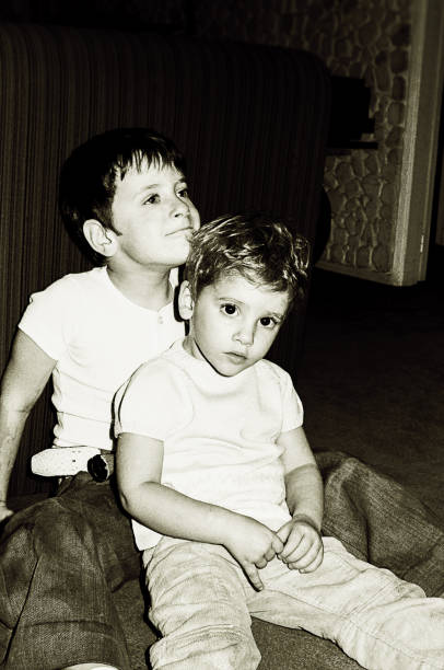 istock Black and white kids sitting on floor at home 918255622