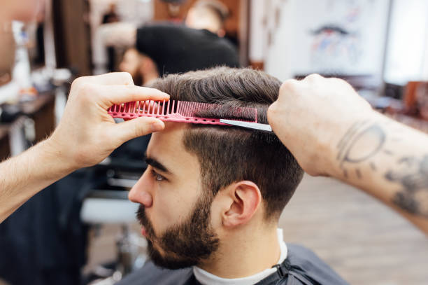 istock man getting trendy haircut at barber shop. 918256052