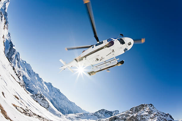 helicopter in air above snow and mountains with sun - heliskiing bildbanksfoton och bilder