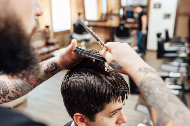 istock man getting trendy haircut at barber shop. 918258164