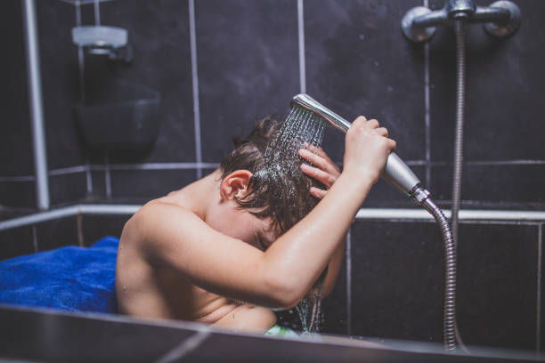 istock Teen boy washing head 918259262