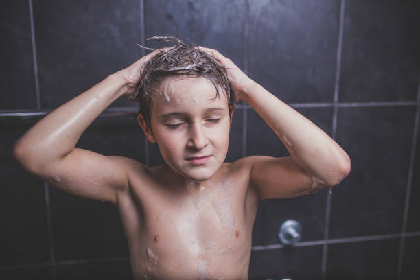 istock Teen boy washing head 918259330