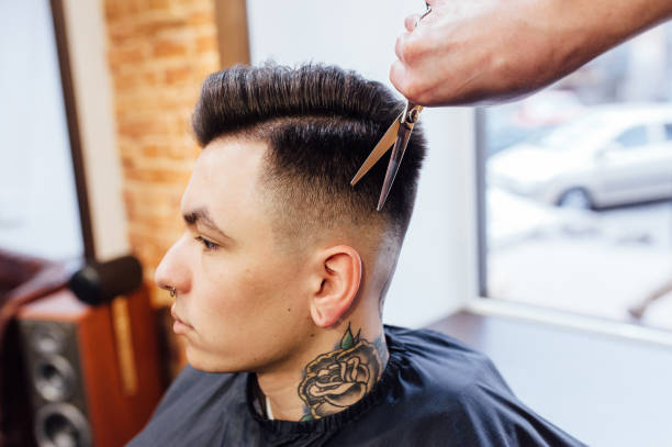 istock man getting trendy haircut at barber shop. 918259528