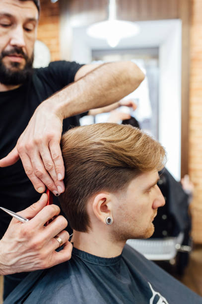 istock man getting trendy haircut at barber shop. 918259946