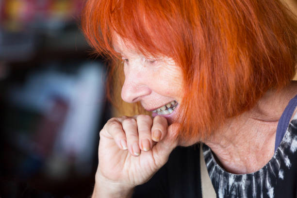 portrait of happy 75 years old woman with red hair - independence lifestyles smiling years imagens e fotografias de stock