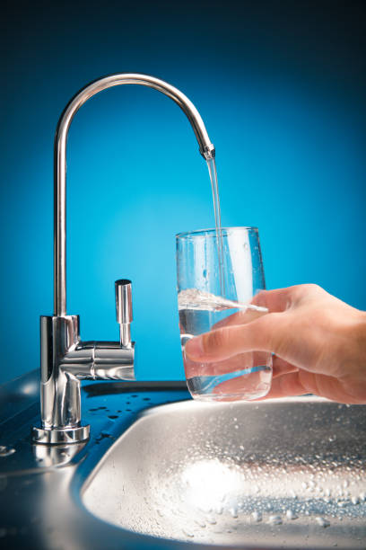 istock hand pouring a glass from water filter tap 918266720