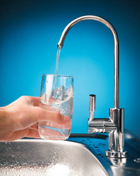 istock hand pouring a glass from water filter tap 918266820