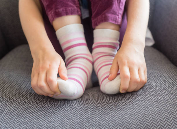 istock Child's hands holding toes 918270194