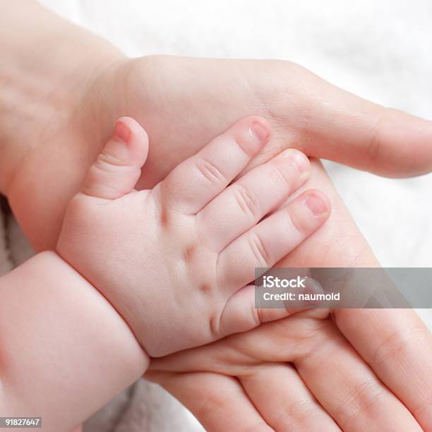 A Mother And Daughter Touch Hands For The First Time Beauty Stock Photo - Download Image Now