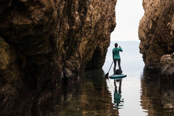 istock Young woman paddling towards the light 918277850