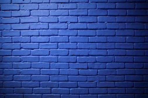 A gradation of light illuminates this large section of a blue brick wall. Hasselblad H3D2.