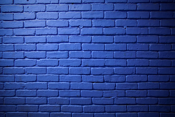 Painted Blue Brick Wall Background A gradation of light illuminates this large section of a blue brick wall. Hasselblad H3D2. brick wall stock pictures, royalty-free photos & images