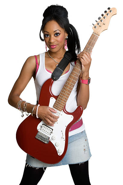 Trendy young hipster woman with curly hair with red guitar in neon lights. Rock musician posing with electrical guitar