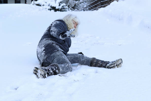 istock A woman slips on the winter road 918283546