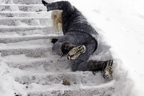 A woman slips on the winter road