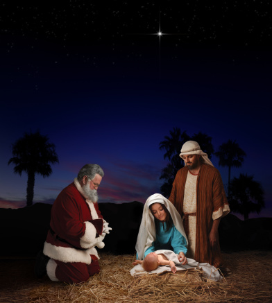 Christmas nativity scene with Santa Claus bowing in homage to baby Jesus in the presence of Mary & Joseph
