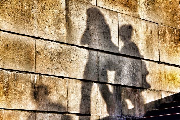 istock shadow of a mother and son on a wall 918289794