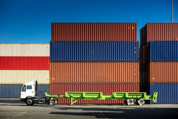 istock Empty Truck Beside Multicolored Shipping Containers 918289968