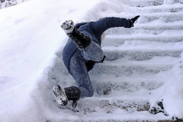 A woman slips and fell on a wintry staircase A woman slips and fell on a wintry staircase. Fall on smooth steps slippery stock pictures, royalty-free photos & images