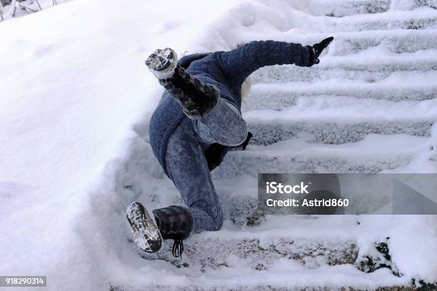 A Woman Slips And Fell On A Wintry Staircase Stock Photo - Download Image Now - Ice, Falling, Slippery