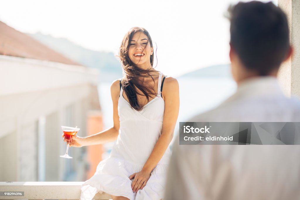 Attractive woman drinking cocktail and enjoying her summer vacation.Drinking refreshing drink and smiling to a man.Flirting and seduction Attractive woman drinking cocktail and enjoying her summer vacation.Drinking refreshing drink and smiling to a man.Flirting and seduction.Man approaching to a woman.Attracted people.One night standAttractive woman drinking cocktail and enjoying her summer vacation.Drinking refreshing drink and smiling to a man.Flirting and seduction.Man approaching to a woman.Attracted people.One night stand Adult Stock Photo