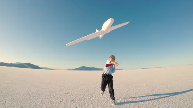 Young Business Boy with Toy Airplane