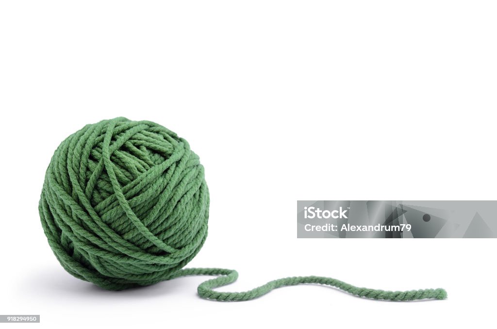 Clew of green thread for knitting isolated on white background Clew of green thread for knitting isolated on white background. Ball Of Wool Stock Photo