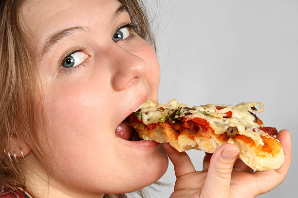 istock Girl eating Pizza 91830194
