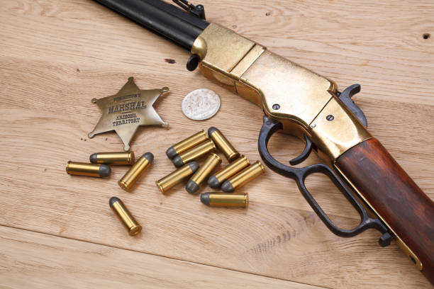 istock Wild west period repeating rifle with ammunition and sheriff badge 918304106
