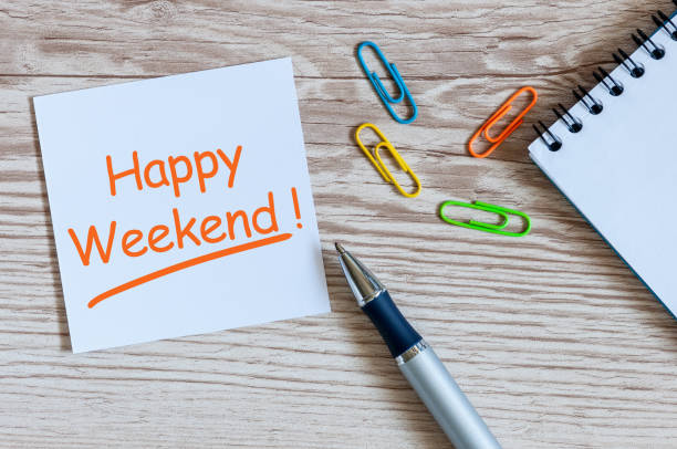istock Note writing Happy Weekend on Office table with supplies, clip, pen 918304818