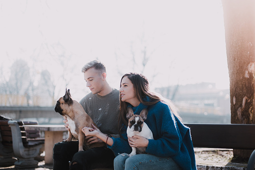 Young couple and  two French Bulldogs