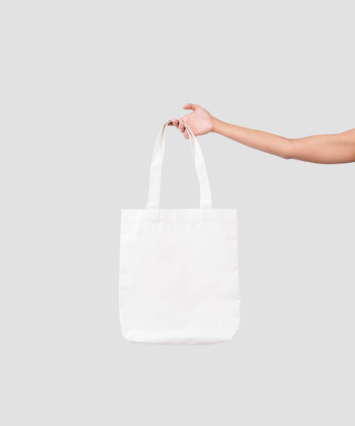 istock hand holding bag canvas fabric for mockup blank template isolated on gray background. 918307996