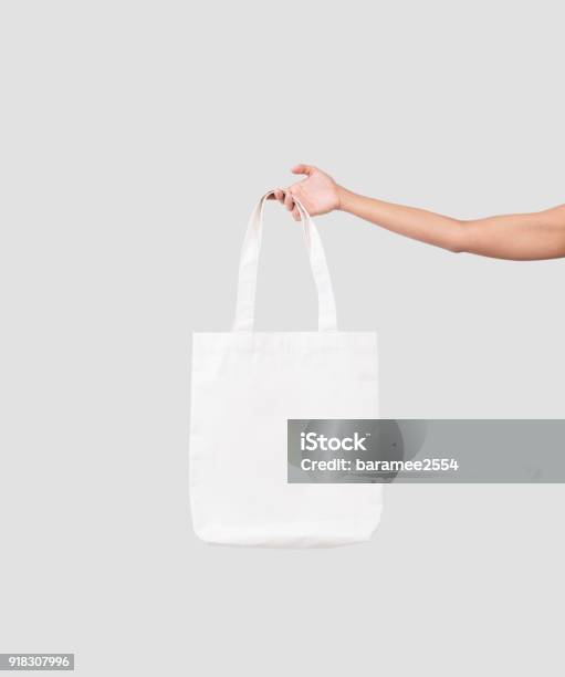 Hand Holding Bag Canvas Fabric For Mockup Blank Template Isolated On Gray Background Stock Photo - Download Image Now