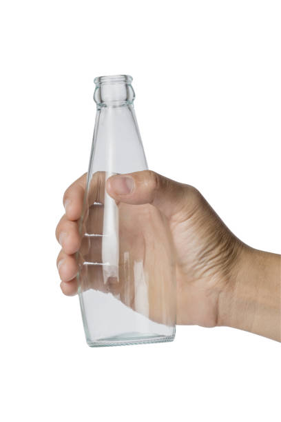 istock Woman's hand holding empty glass bottle transparent on white background, File contains a clipping path. 918312130