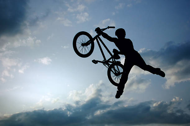 istock silhouette of boy with bicycle 91831417
