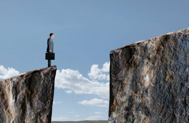 istock Businessman Standing At Edge Of Cliff 918314594