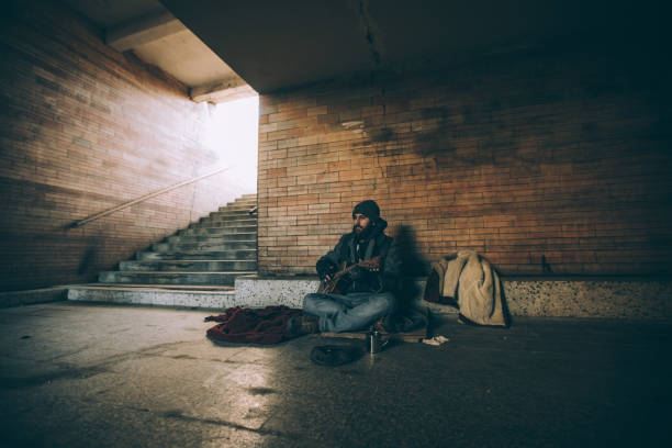 istock Homeless man playing guitar 918315316