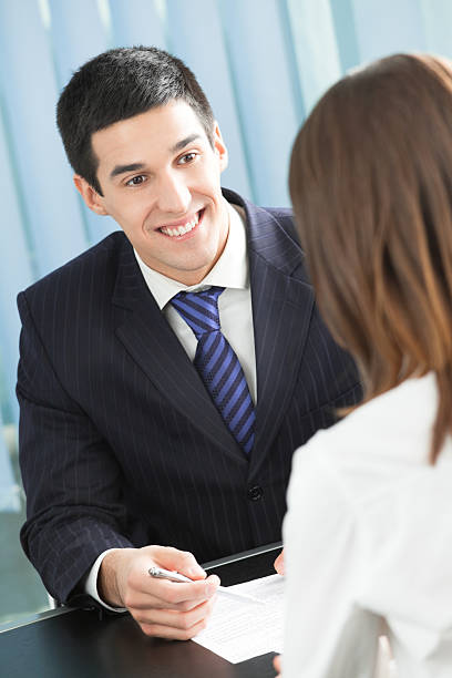 istock Two businesspeople, or businessman and client, with document at office 91831789