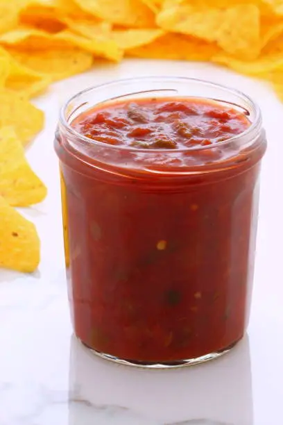 Artisan mexican dip salsa on vintage carrara marble table, with a delicious fresh mexican or tex-mex flavor