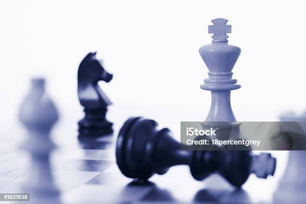 Chess Game White King Defeating Black Stock Photo - Download Image Now - Bishop - Chess Piece, Black Color, Blue