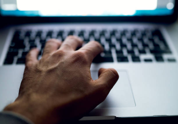 istock Close up of man hand typing text on laptop keyboard 918318474